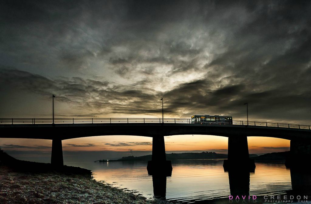 An early morning bus crosses the bridge to Rocky Island on its way to the Naval Base in Haulbowline, Co. Cork.                                     