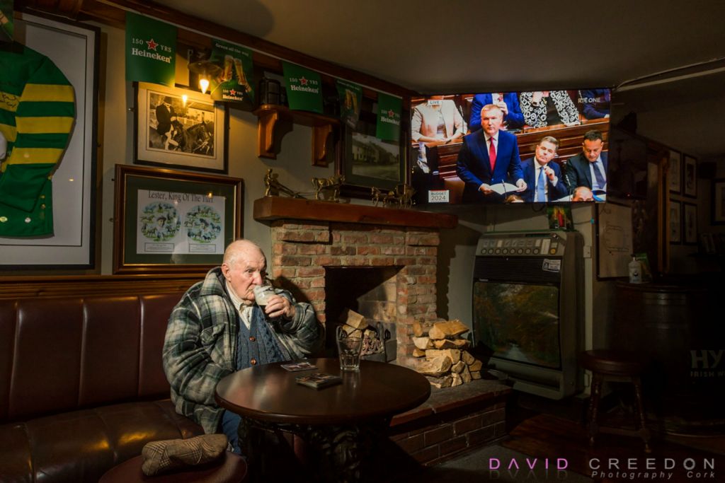 Enjoying a quite pint of stout  in his local bar   