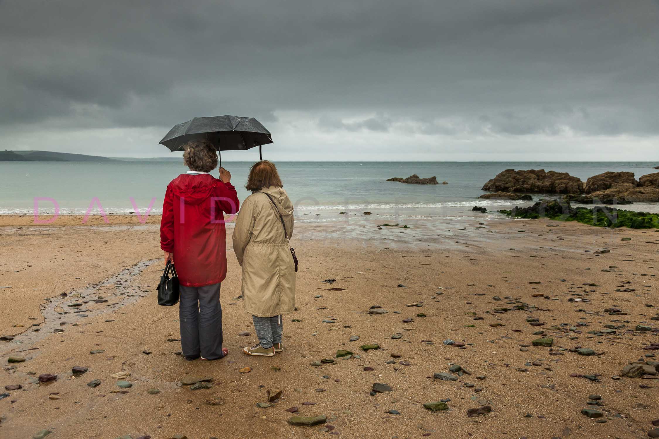 Two Ladies on the Beach in the Rain