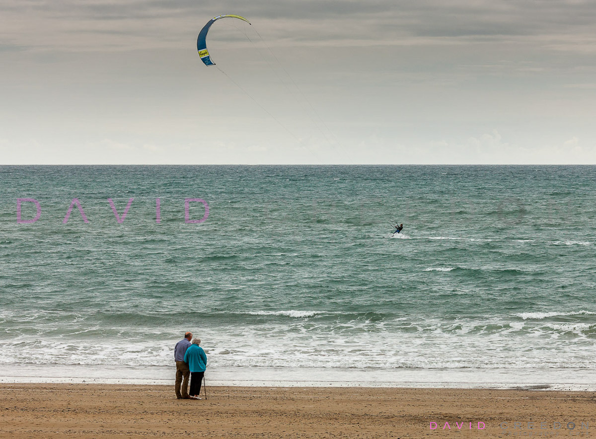 Elderly couple watch kitesurfer at Garretstown Co. Cork
