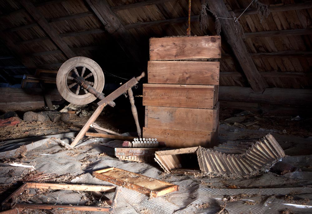 Spinning wheel, Bee hives and an broken accordion lie in the loft of the home of Helena Girvaite.Helena has one daughter who now lives in Velikiji Luki, Russia and works for the State Archive. She is married with two sons who also live in Russia. In a letter to her mother in 2002, she tells her that her eldest son, Juris, is about to get married to a Russian girl named Olga. He had just graduated from the military academy while her younger son was still in school. She wrote to her mother quite seldom and had invited her to travel to Russia but it seems that it did not work out. Helena was quite precise at recording details of the farm, such as dates when the hens were to be put on eggs and also kept track of the farm accountslendar on the wall is dated April 2010 which may give an indication of the last occupancy, while the hands of the clock have stopped at 10:04.Helena lived with her husband who died in 2002. He worked with tractors, ploughing land and travelling around local villages.