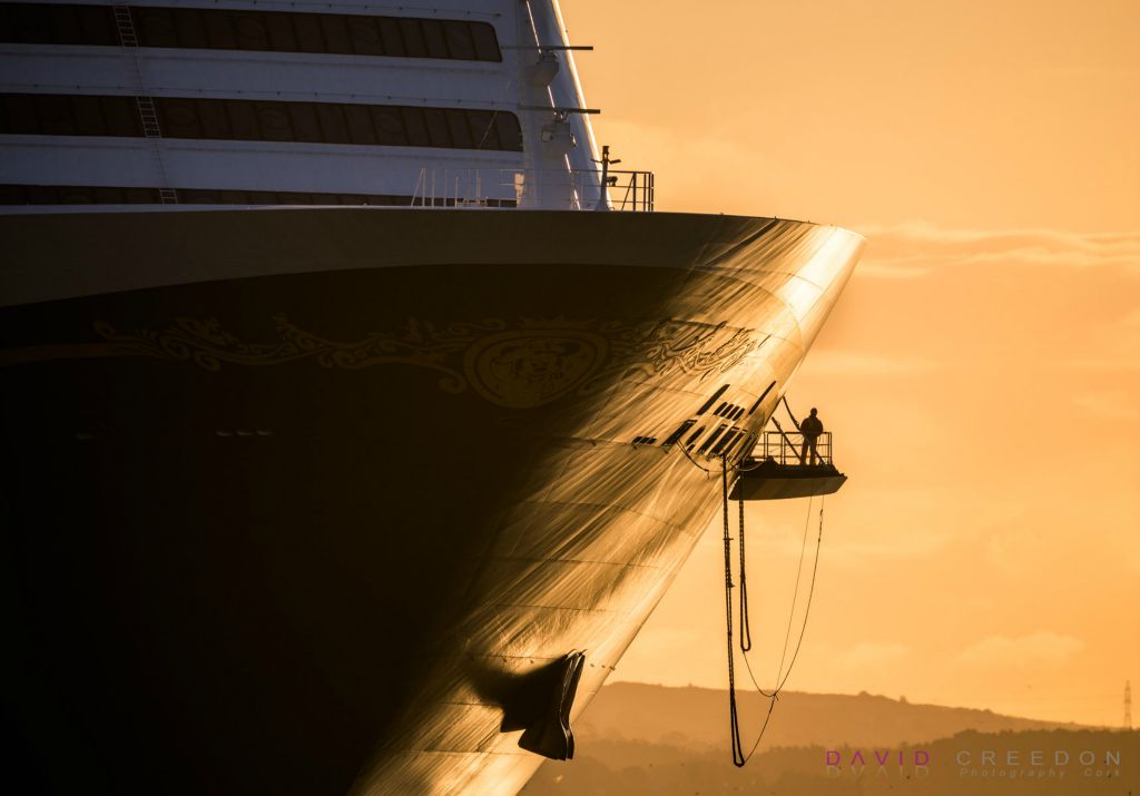 A deckhand of the cruise ship Disney Dream oversees the dropping of mooring lines in preperation for docking at the deep water berth in Cobh, Co. Cork.  