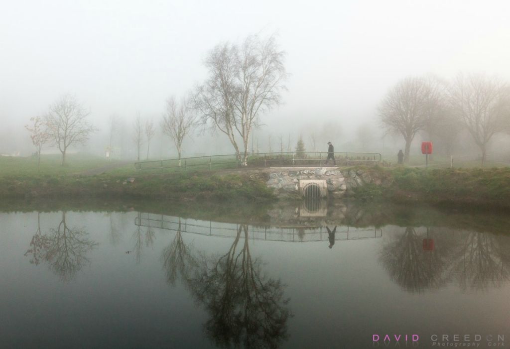 A man walks  in early morning fog through the community Park in Carrigaline, Co. Cork.  