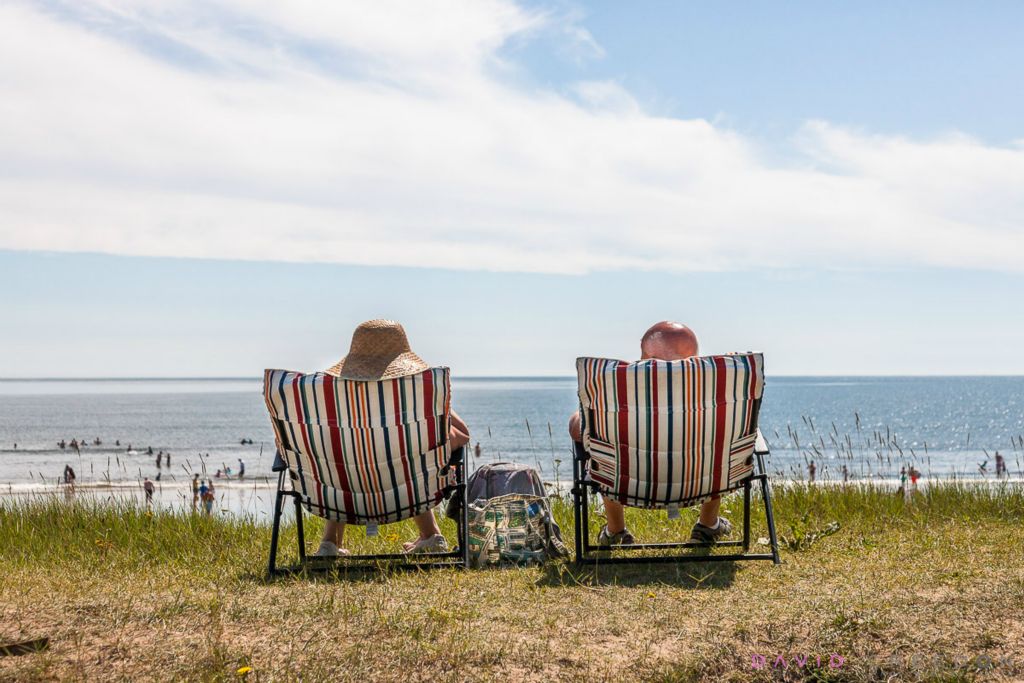 With tempertures hitting 23 degrees, Mary and Kieran Collins from Blarney sunbath on deckchairs at the seafront in Claycastle, Co. Cork, Ireland. 